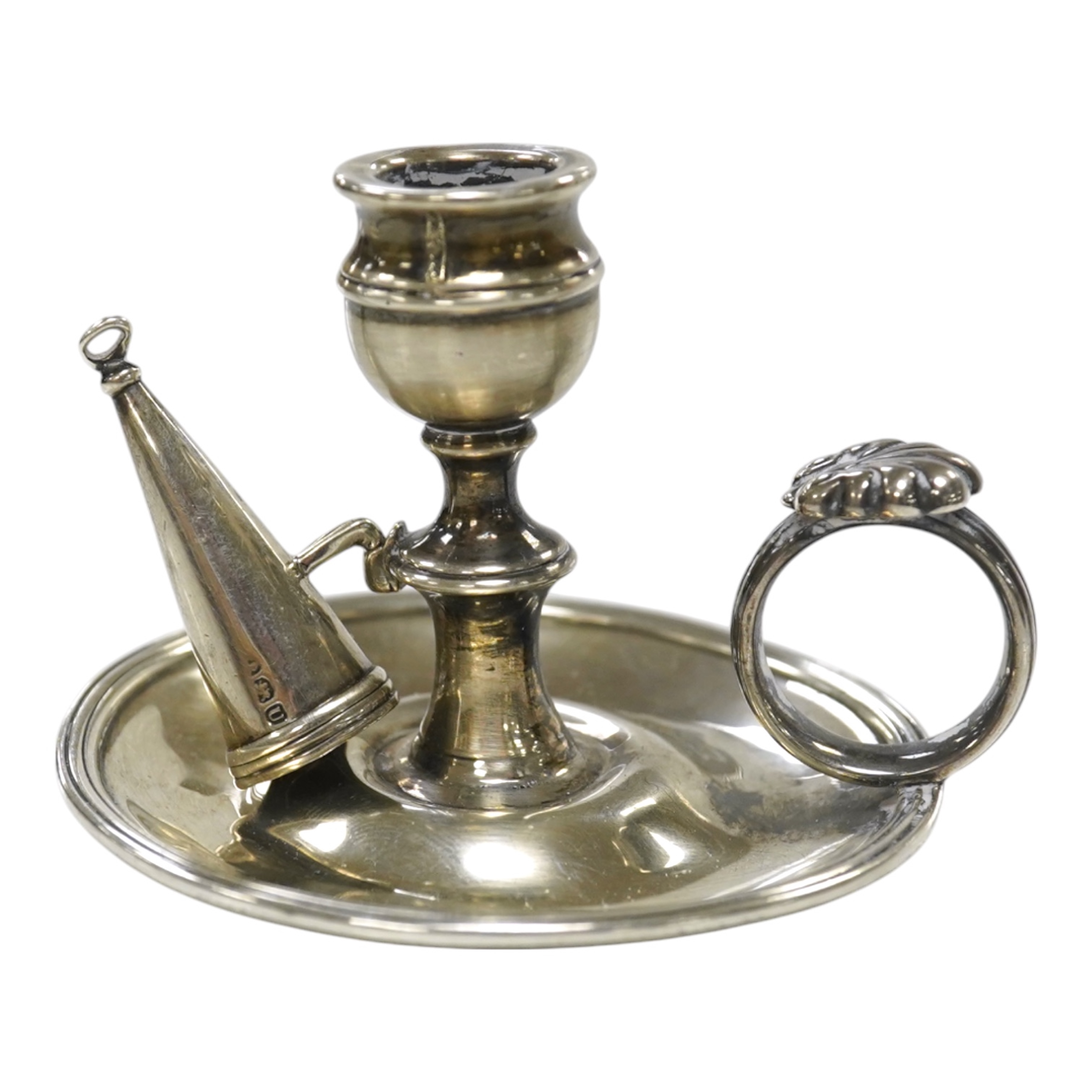 A George III miniature silver chamber stick, Emes & Barnard, London, 1815(a.f.), with matching extinguisher, base diameter 75mm. Condition - poor